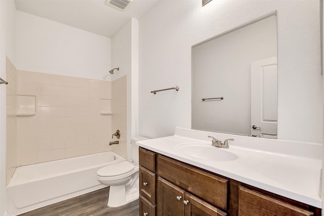 full bathroom with hardwood / wood-style floors, vanity, toilet, and bathing tub / shower combination