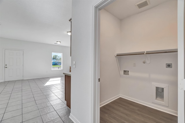 washroom with tile patterned flooring, washer hookup, gas dryer hookup, and electric dryer hookup