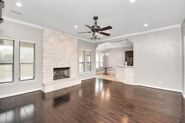 unfurnished living room with dark hardwood / wood-style floors, a fireplace, and a textured ceiling