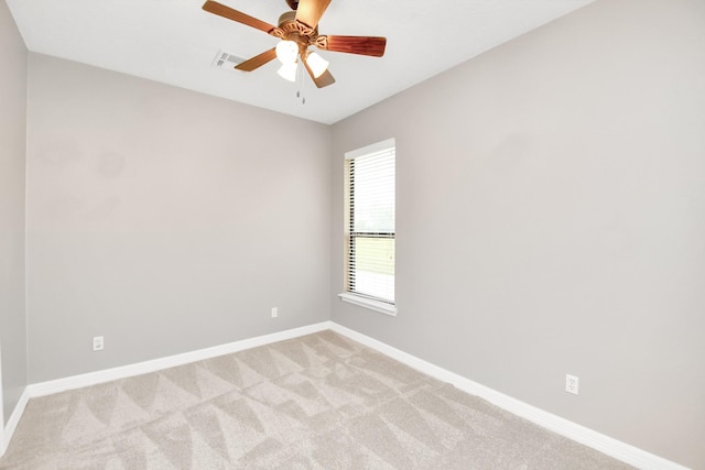 carpeted spare room with ceiling fan