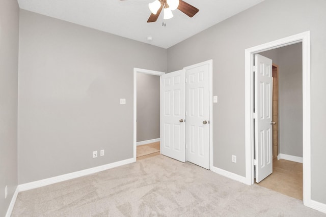 unfurnished bedroom with light colored carpet and ceiling fan