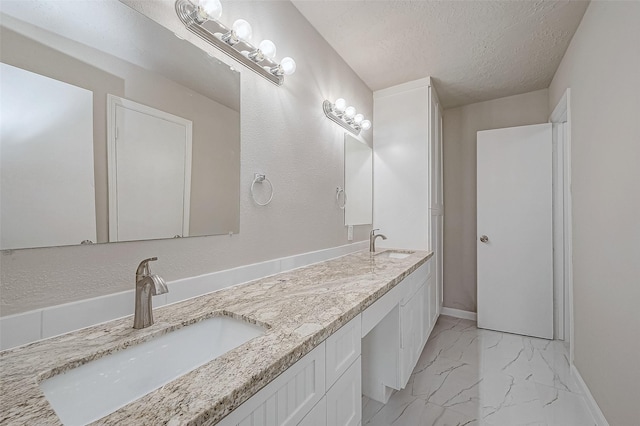 bathroom with vanity and a textured ceiling