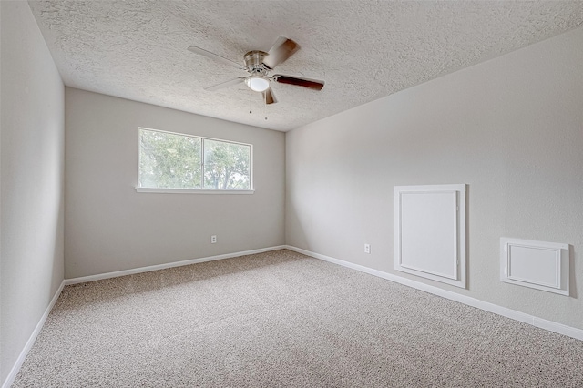 empty room featuring a textured ceiling, carpet floors, and ceiling fan