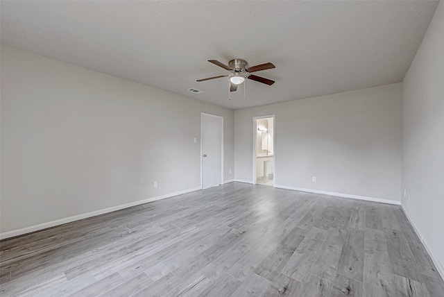 empty room with ceiling fan and light wood-type flooring