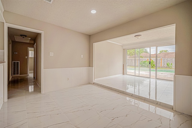 empty room featuring a textured ceiling