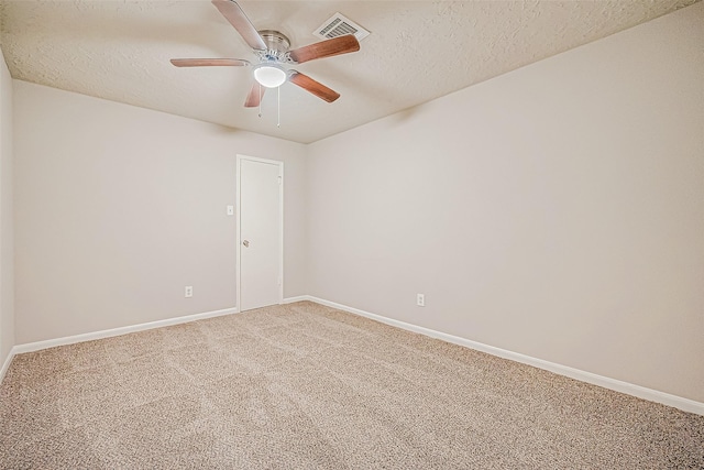 unfurnished room with carpet and a textured ceiling