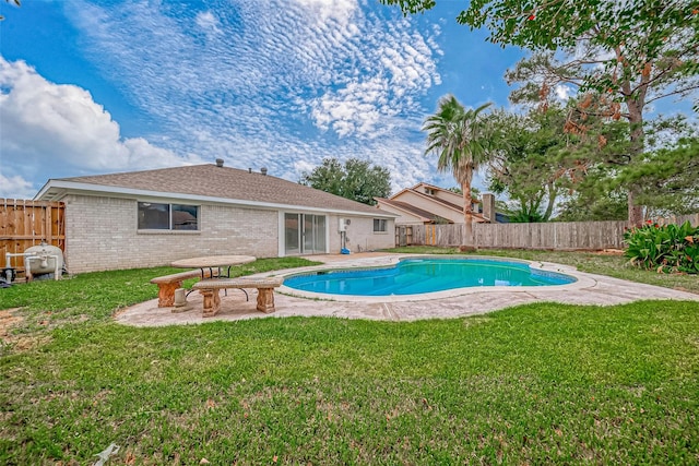 view of pool featuring a yard and a patio