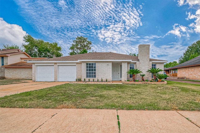 view of front of house with a garage and a front lawn