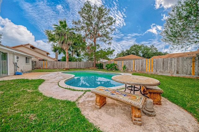 view of swimming pool featuring a yard and a patio area