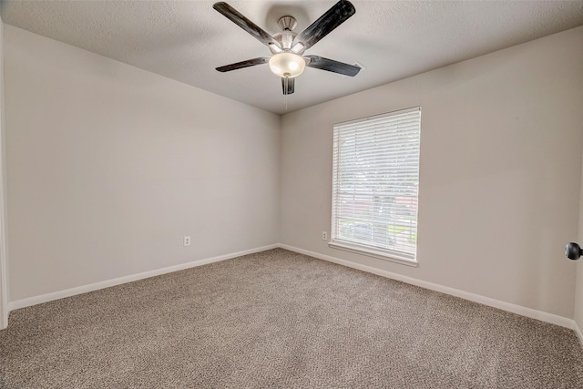 empty room with carpet flooring, a textured ceiling, and ceiling fan