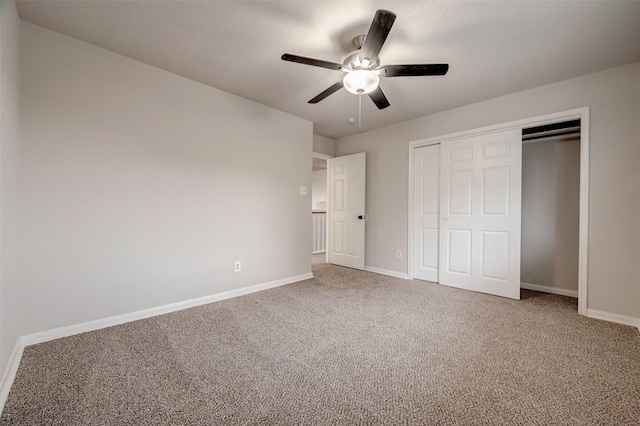 unfurnished bedroom with ceiling fan, a closet, and carpet floors