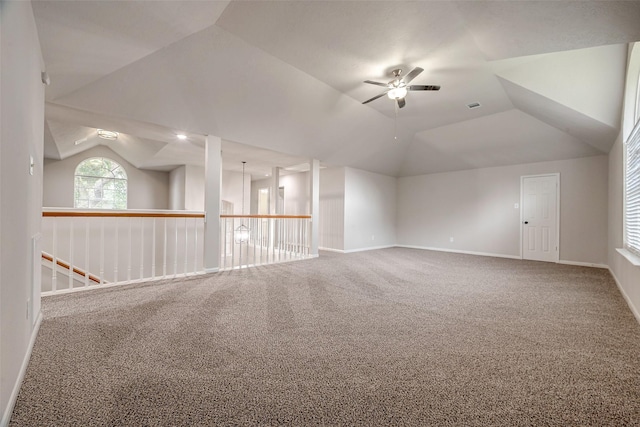 spare room featuring carpet, ceiling fan, and vaulted ceiling