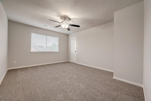 spare room featuring carpet flooring, a textured ceiling, and ceiling fan