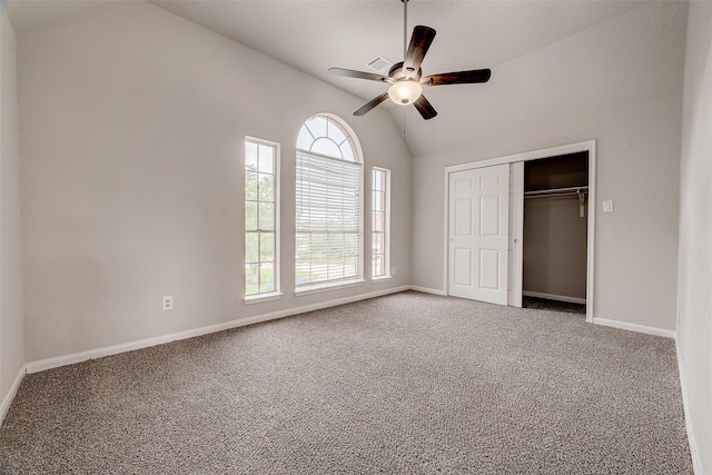 unfurnished bedroom featuring carpet flooring, ceiling fan, a closet, and vaulted ceiling