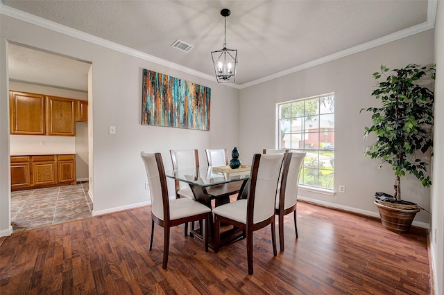 dining space featuring a notable chandelier, dark hardwood / wood-style floors, crown molding, and a textured ceiling