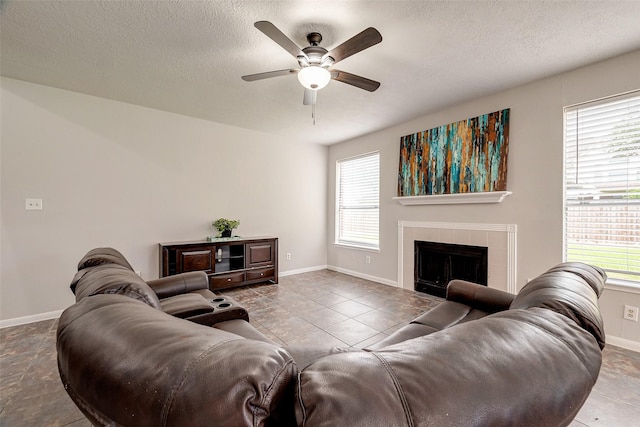 tiled living room featuring a healthy amount of sunlight and a textured ceiling