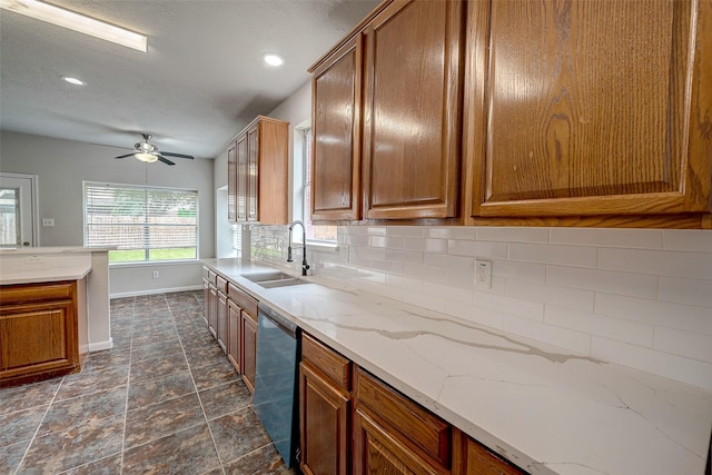 kitchen with decorative backsplash, light stone counters, stainless steel dishwasher, ceiling fan, and sink