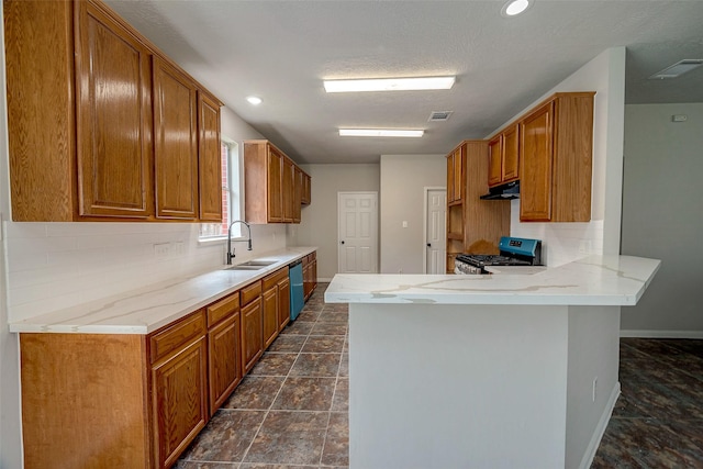 kitchen with kitchen peninsula, gas stove, tasteful backsplash, and sink