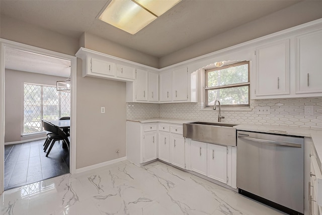 kitchen with tasteful backsplash, a wealth of natural light, sink, and stainless steel dishwasher