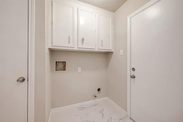 washroom featuring cabinets, hookup for an electric dryer, hookup for a gas dryer, hookup for a washing machine, and a textured ceiling