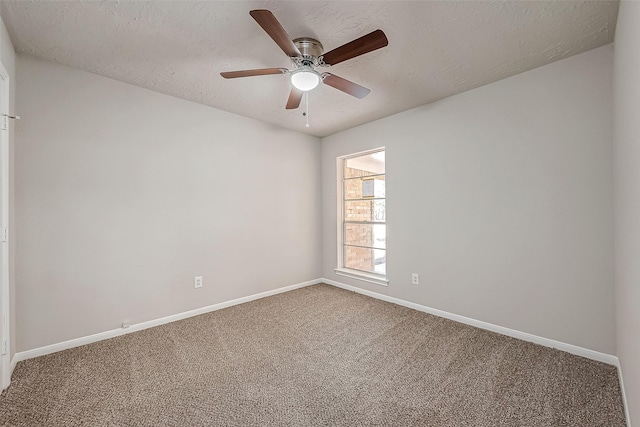 carpeted empty room with ceiling fan and a textured ceiling