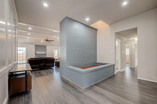 interior space featuring wood-type flooring and brick wall