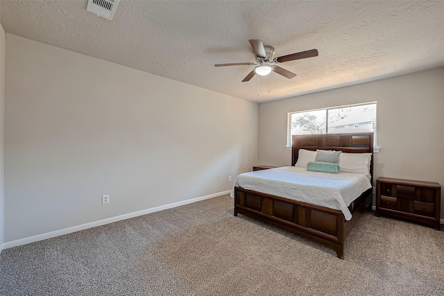 bedroom featuring ceiling fan, carpet floors, and a textured ceiling