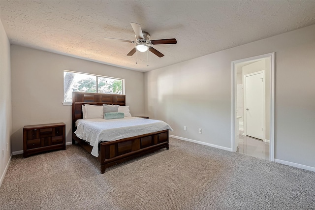 bedroom featuring connected bathroom, ceiling fan, carpet, and a textured ceiling