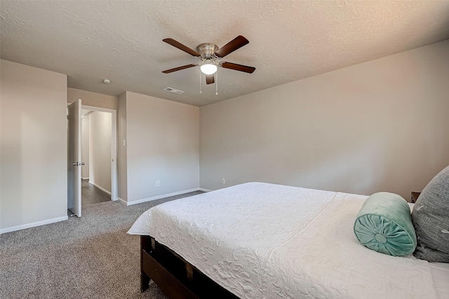 carpeted bedroom with a textured ceiling and ceiling fan