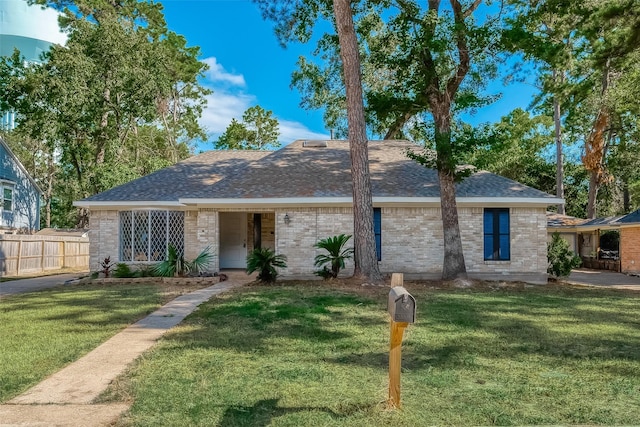 ranch-style home featuring a front yard