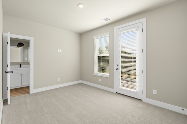 empty room with sink and light carpet