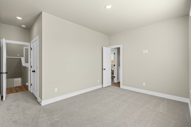 unfurnished bedroom with light colored carpet