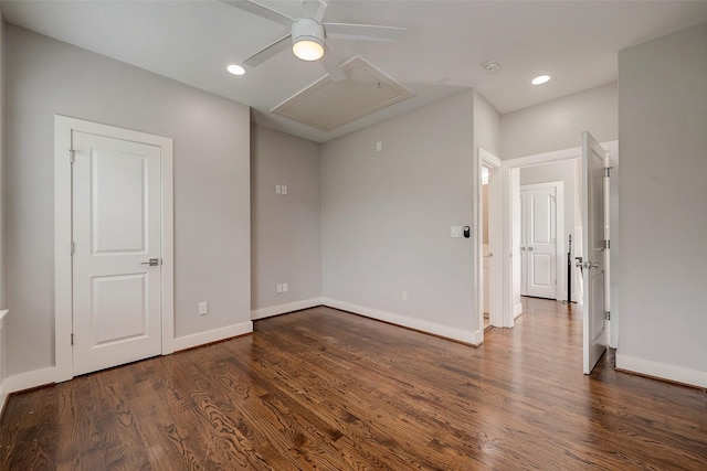 spare room featuring attic access, recessed lighting, baseboards, and wood finished floors