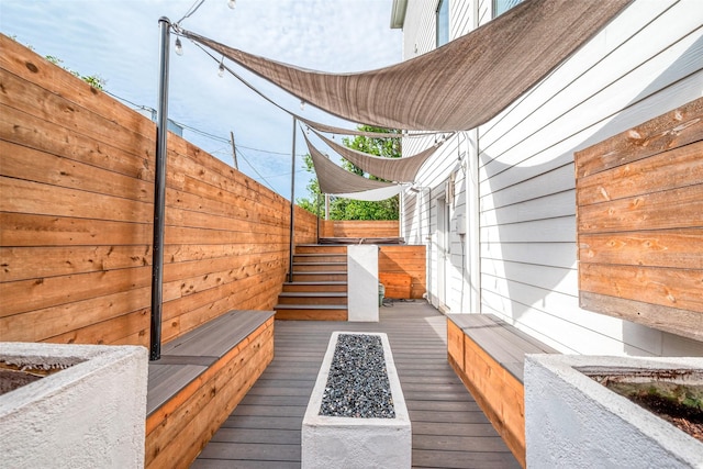 exterior space featuring an outdoor fire pit, fence, and stairs