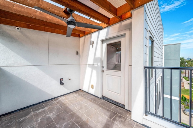 view of exterior entry featuring ceiling fan