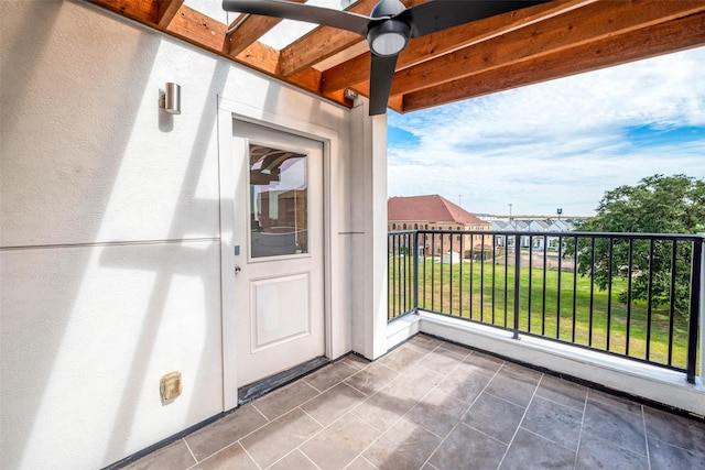 entrance to property featuring a balcony and stucco siding