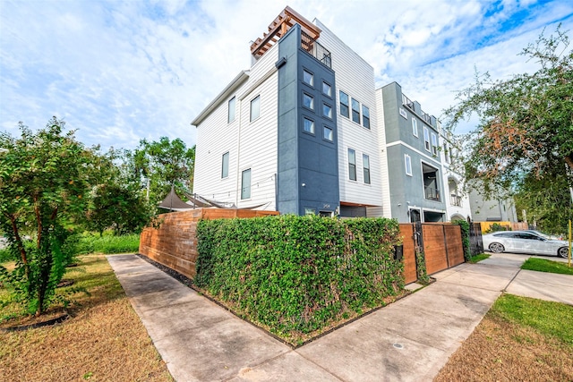 view of home's exterior featuring fence