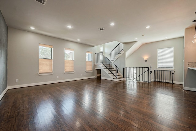 unfurnished living room featuring baseboards, visible vents, wood finished floors, and recessed lighting