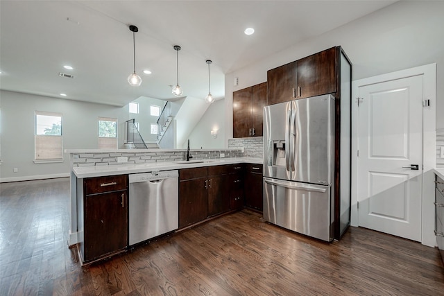 kitchen featuring kitchen peninsula, dark hardwood / wood-style flooring, stainless steel appliances, and sink