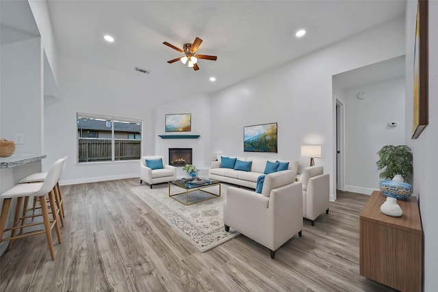 living room with ceiling fan and light hardwood / wood-style floors