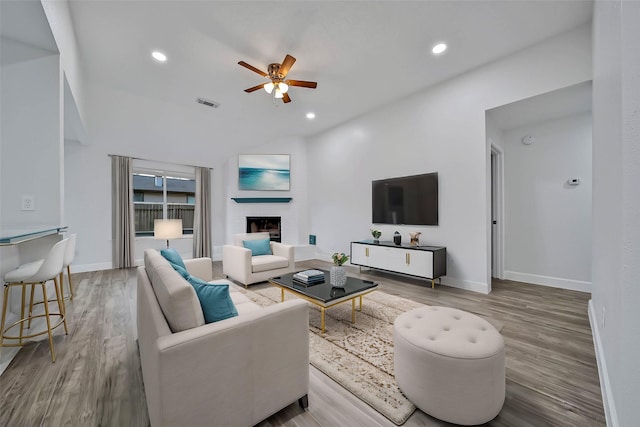 living room with ceiling fan and hardwood / wood-style flooring