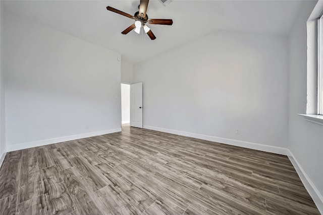 spare room featuring light wood-type flooring, vaulted ceiling, and ceiling fan