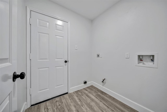 washroom featuring washer hookup, hookup for an electric dryer, gas dryer hookup, and light hardwood / wood-style flooring