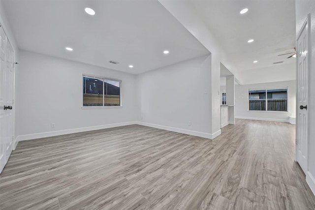 unfurnished living room featuring light wood-type flooring and ceiling fan