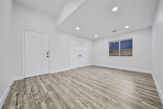 spare room with light hardwood / wood-style flooring