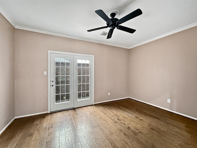 spare room featuring ceiling fan, wood-type flooring, and ornamental molding