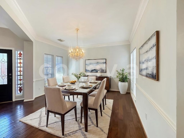 dining room featuring a chandelier, dark hardwood / wood-style flooring, and crown molding