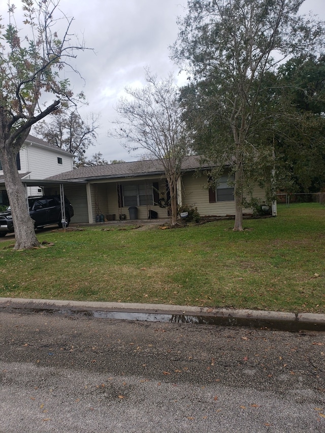 view of front of home with a front lawn and a carport