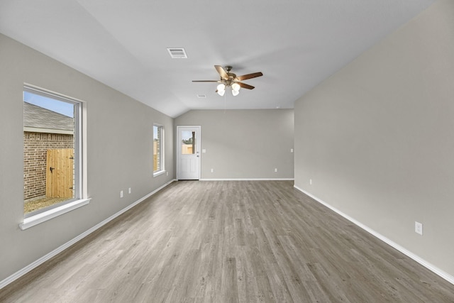 spare room with ceiling fan, hardwood / wood-style floors, and vaulted ceiling