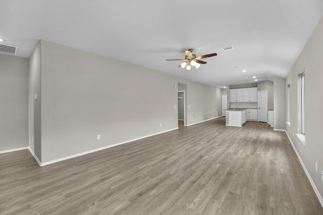 unfurnished living room featuring light wood-type flooring and ceiling fan